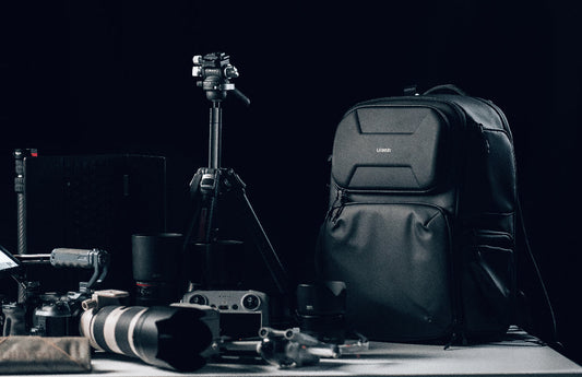 A sleek camera bag alongside several camera lenses.