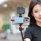 Smartphone and camera mounted on tripod for content creation