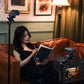 Woman reading book on couch next to camera with wireless flash trigger