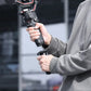 User holding a gimbal with Ulanzi quick release plate for dynamic shooting.